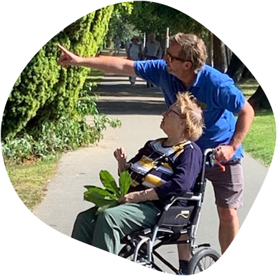 Lady in a wheelchair taken around a park