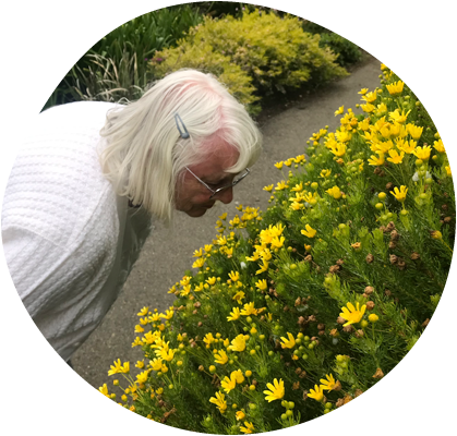 Lady smelling yellow flowers