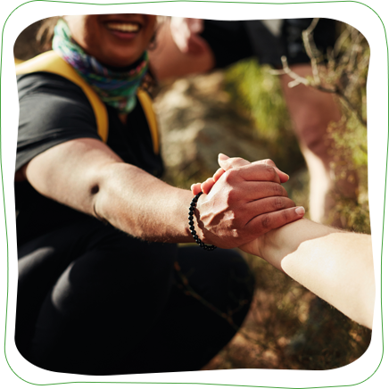 Someone giving a helping hand up a hill