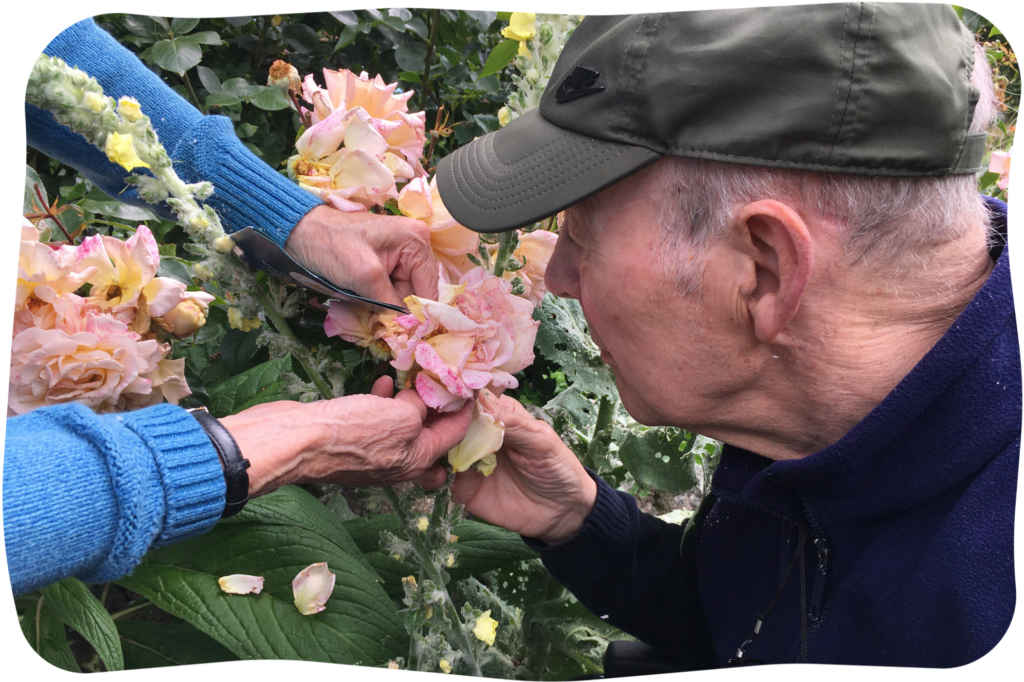 Man smelling a rose.