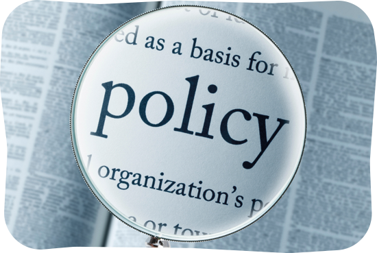 Magnifying glass over the word 'policy'