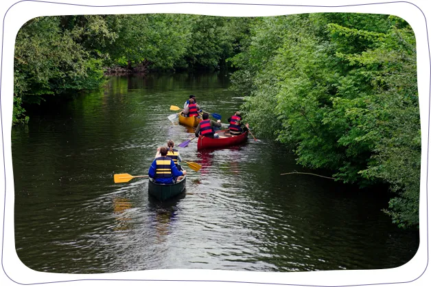 Group kayaking down a river